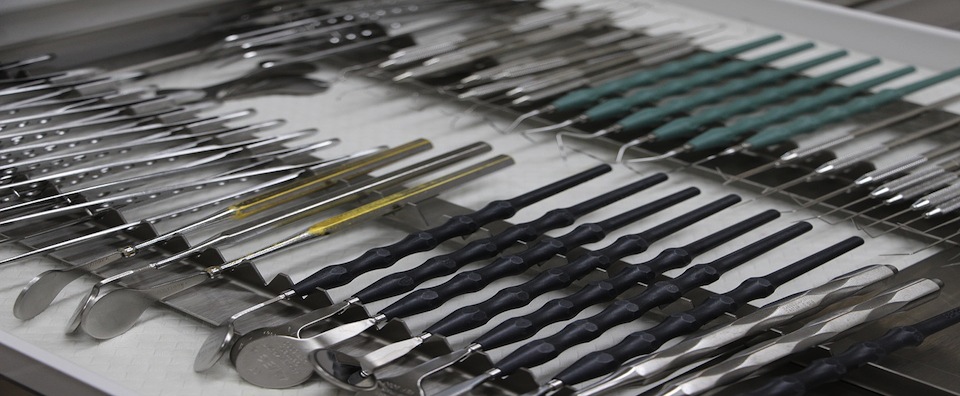 Dental instruments lined up on a tray
