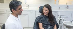 Dr Asif Chatoo and a patient at The London Lingual Orthodontic Clinic