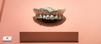 An exhibit of a metal moulded set of top teeth