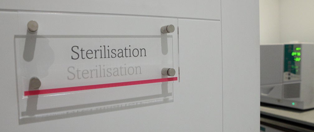 Covid-19 precautions sterilisation sign on door