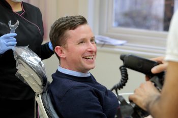 A patient smiling in the dentist chair