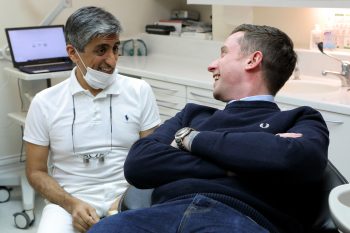 Dr Asif chatting to a patient in the clinic