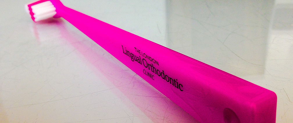 Branded pink toothbursh from The London Lingual Orthodontic Clinic