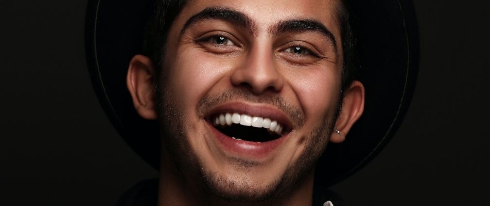 Man smiling, dark background